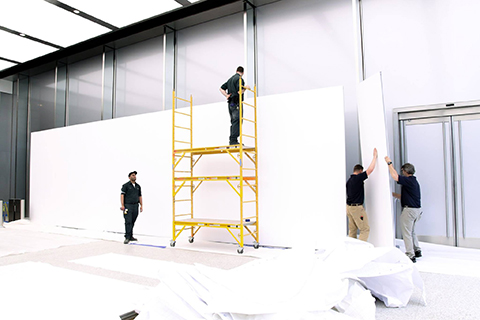 MBA employees with scaffolding during the exhibition setup with Mila-wall partitions